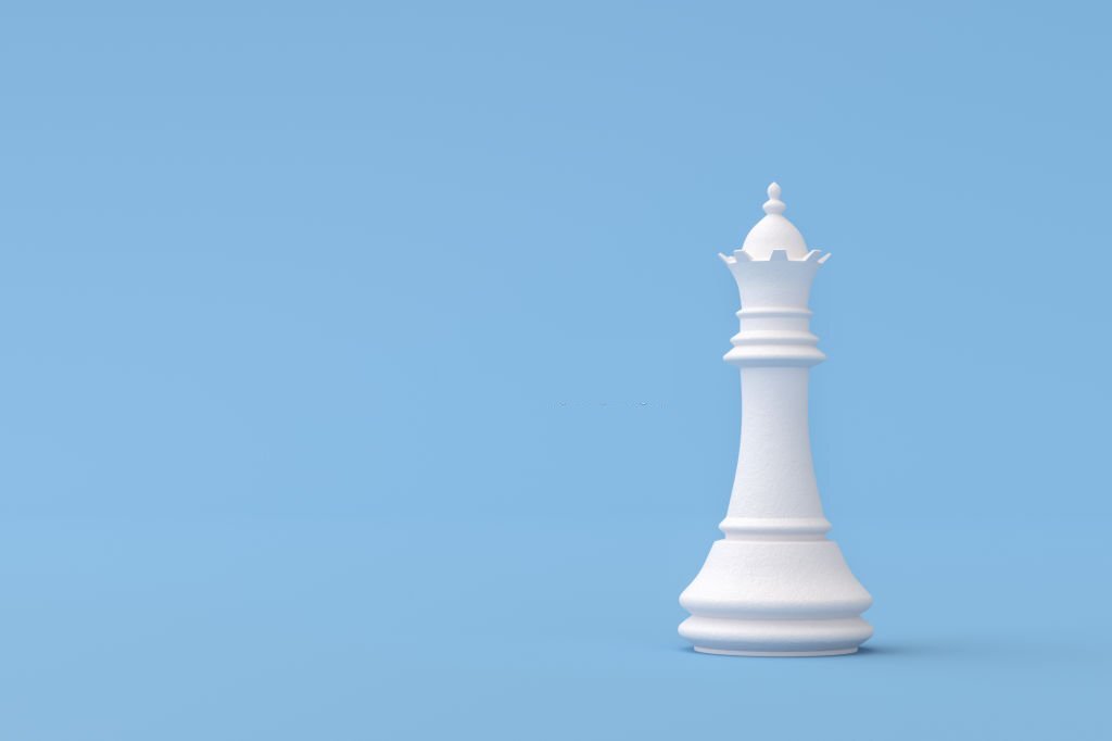 Plaster Queen Chess Piece on blue background